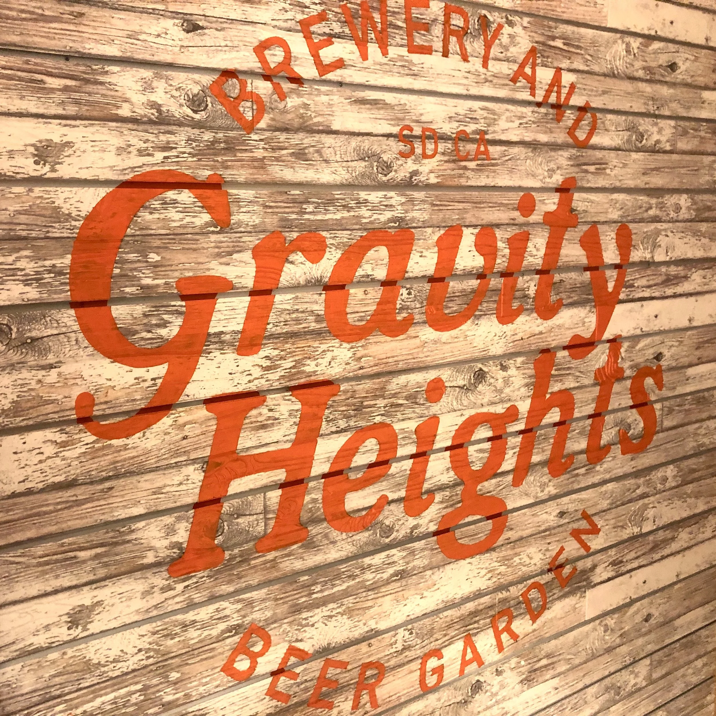 Recent work: hand painted restaurant branding logo on distressed wood in San Diego