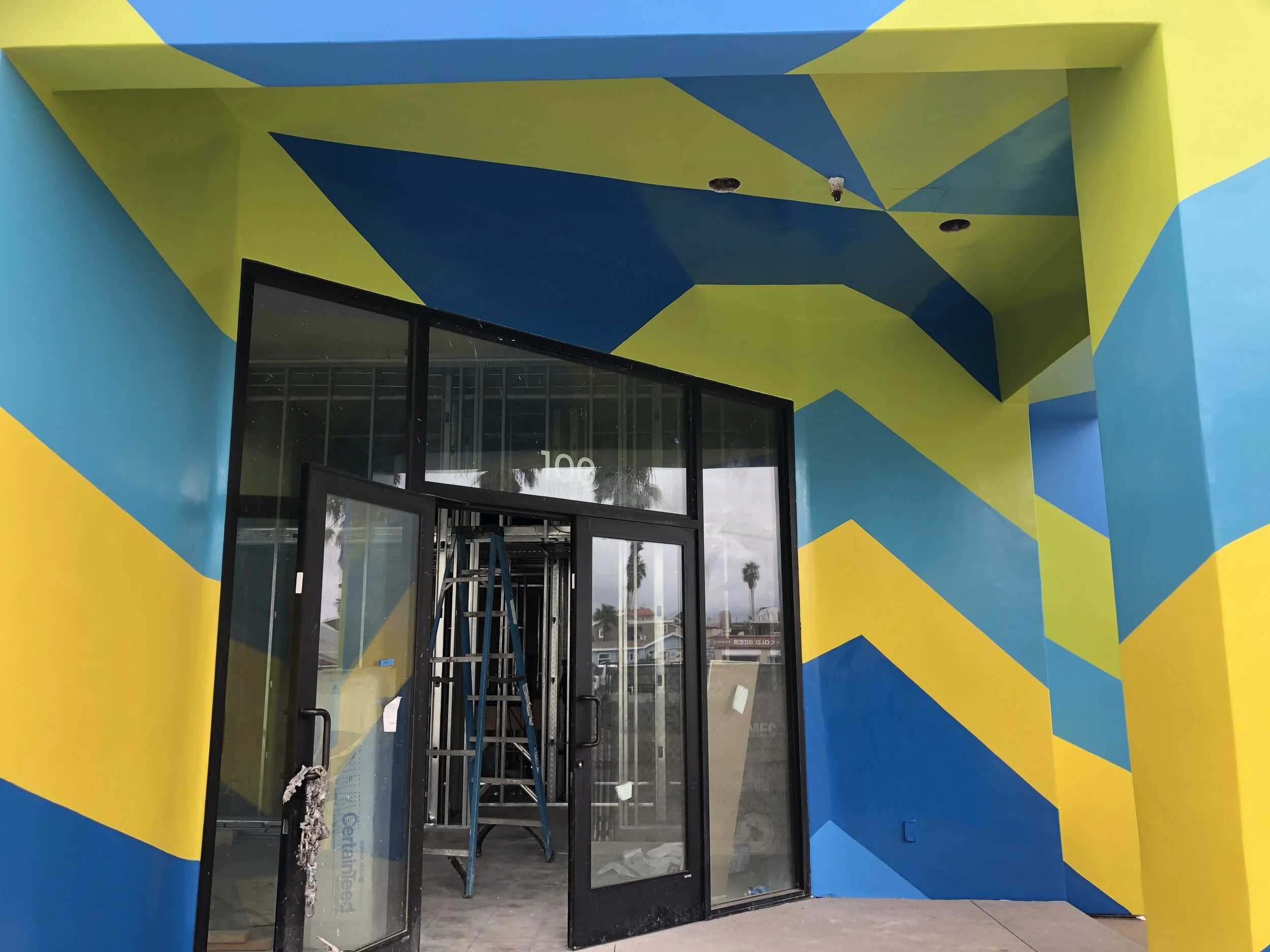 The short video below shows the entry area - all of the blocks of color on the building had to come to a point here. I started calling this the Bermuda Triangle of Paint!