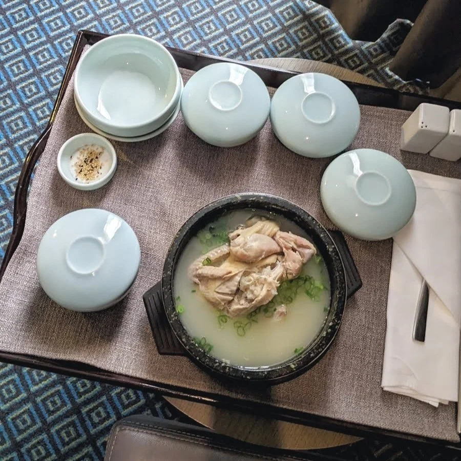 Beautiful Korean Hotel Room Service for Samgyetang. What are under the bowl covers, it’s all a delightful surprise!