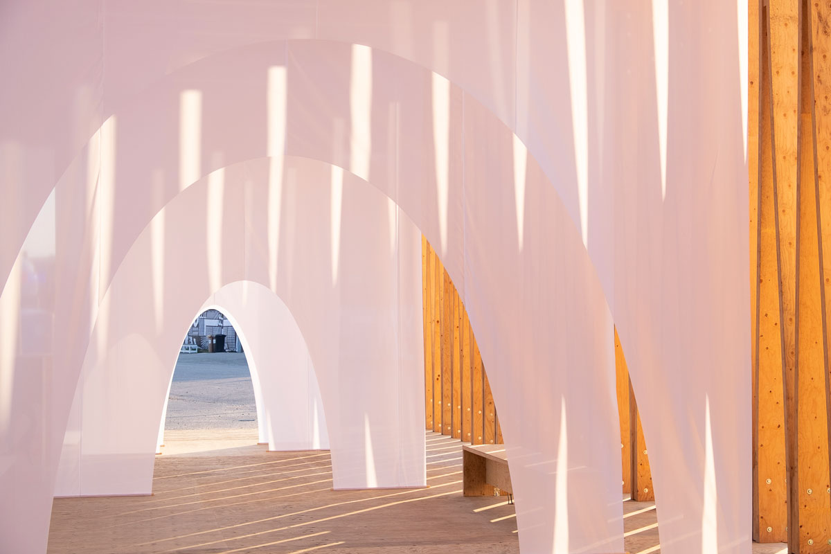 The installation is made out of 600 meters of fabric and aims to be a space of transition between the hyper sensorial experiences happening at the festival.