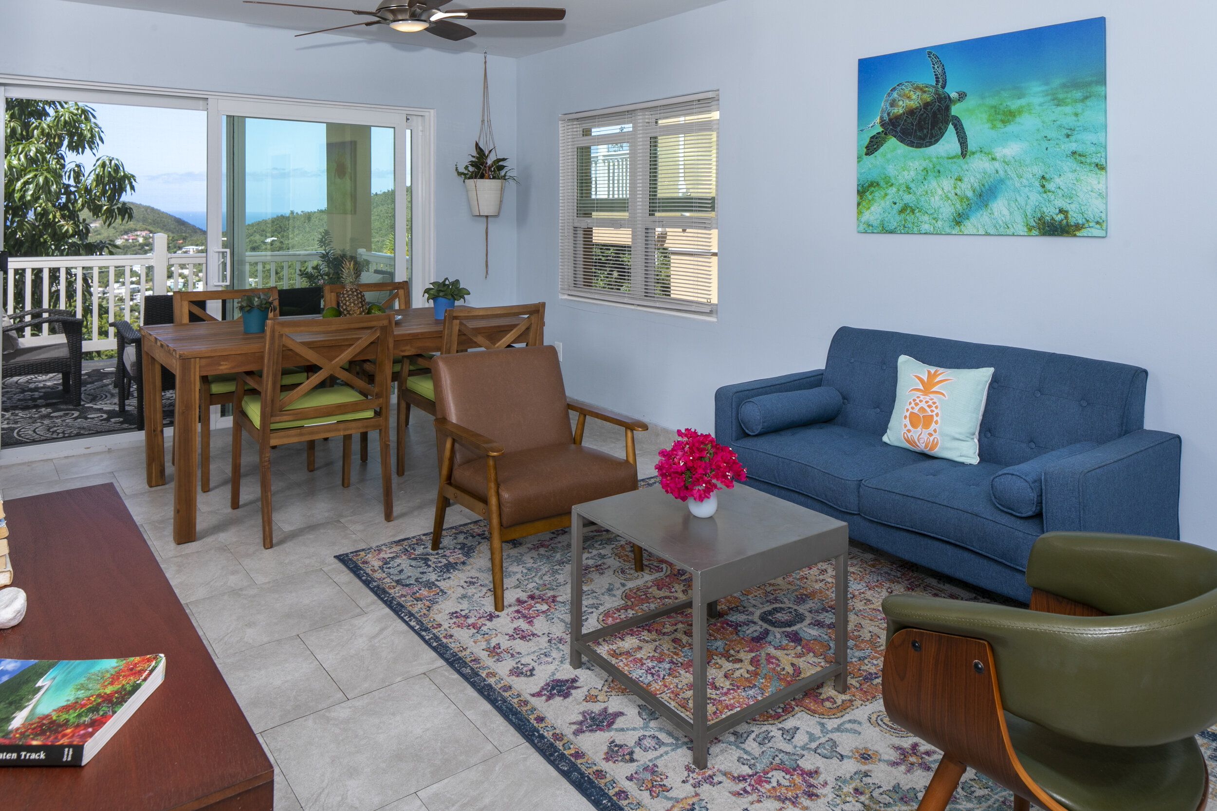 Living area has been updated with a full size sofa, new chair, and the table is now located on the private deck