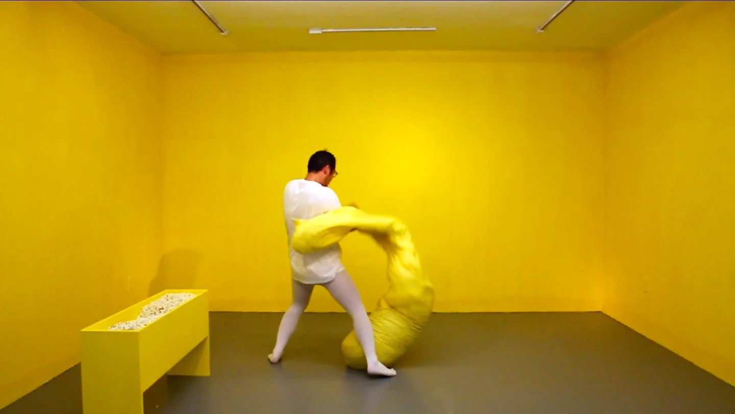 Yellow (video still) 2017. Artist, bean bag, popcorn. Dimension variable