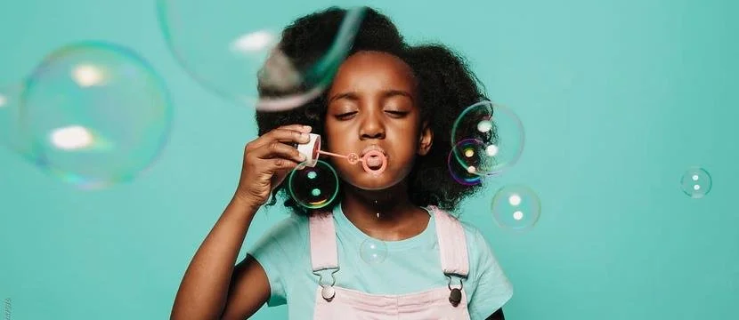 girl blowing bubbles
