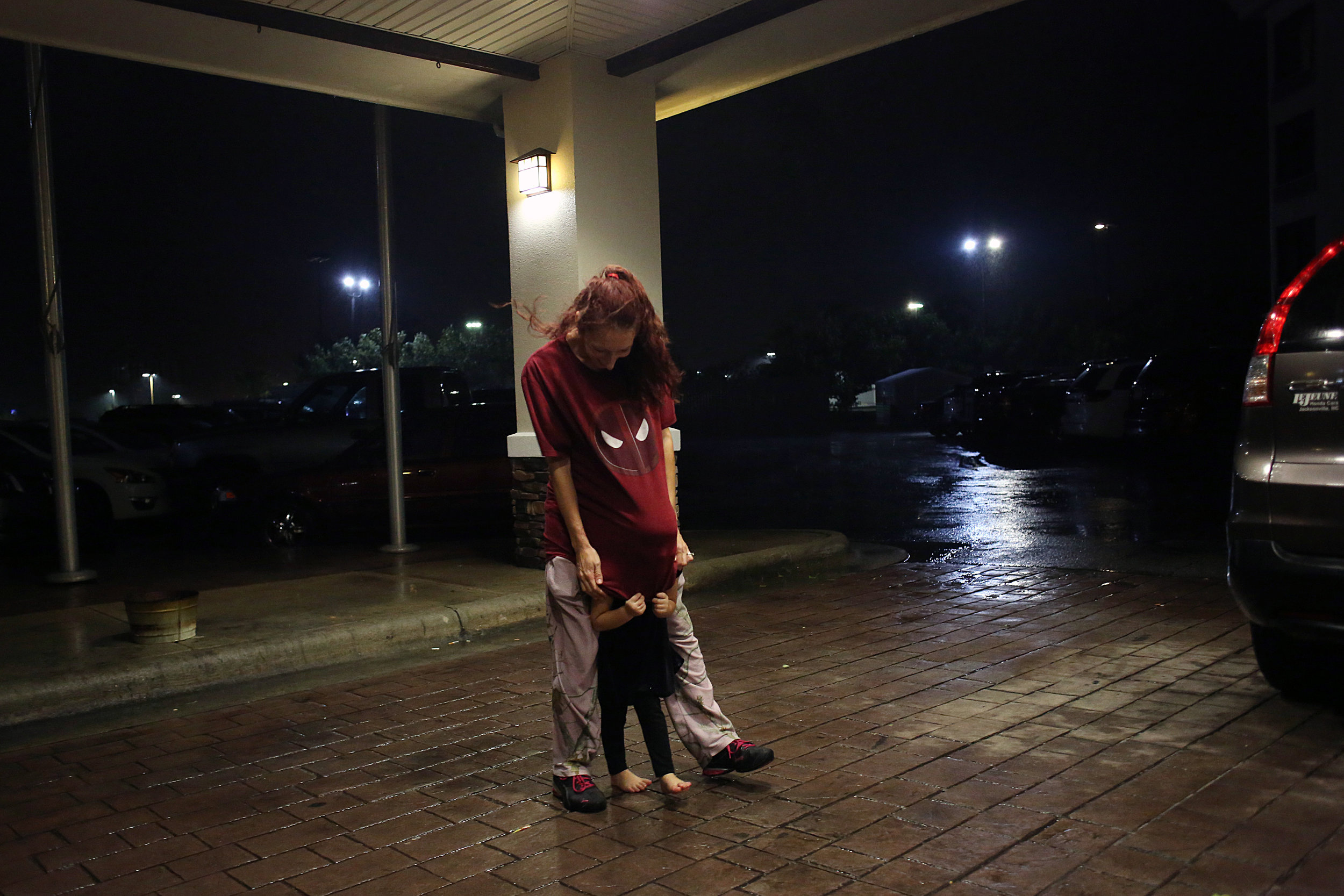 Allana Bailey, of Hubert, plays with her daughter, Brooklynn Lowe, 3, outside of the Holiday Inn Express as Hurricane Florence rolled in, Sept. 13 in Jacksonville, N.C. "They're tired of being cooped up in the room -- but they've got a pocketful of energy," Bailey said of her twin daughters, who she calls 'twinados'.