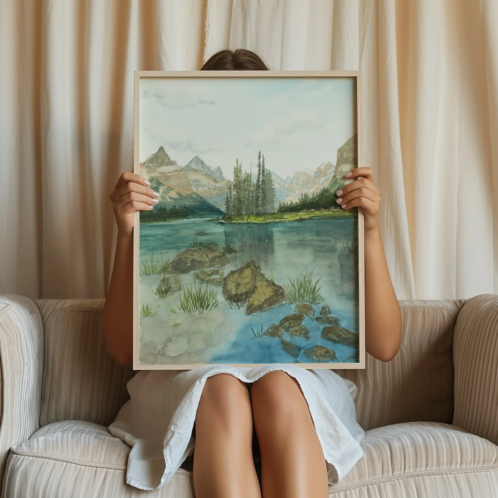Spirit Island, Jasper National Park watercolor mountain landscape wall art print inspired by towering peaks and vibrant blue mountain lakes in the Canadian Rockies framed print held by a woman