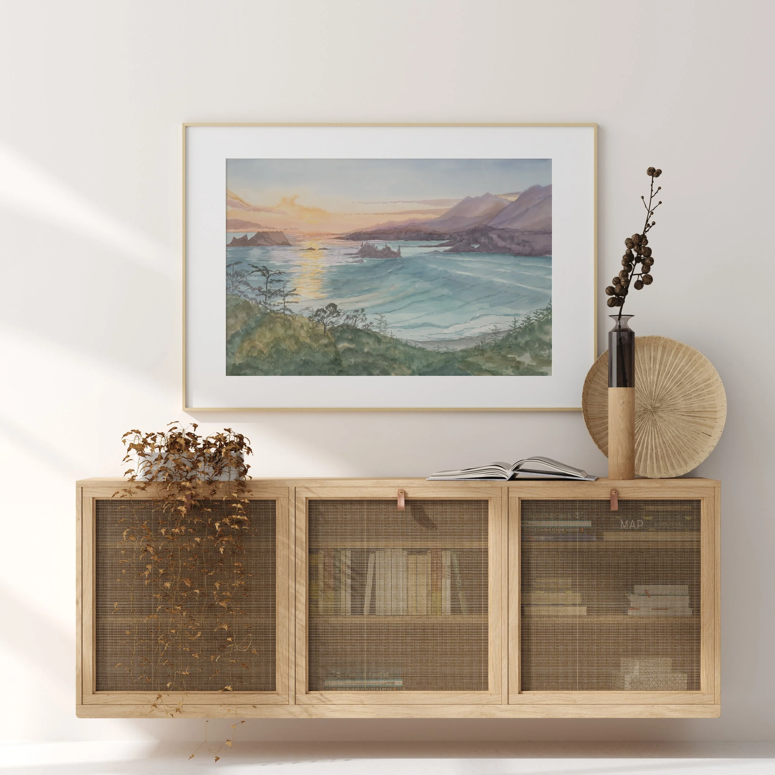 Coastal watercolor landscape art print of Cox Bay lookout in Tofino, BC. hanging above a wood buffet.