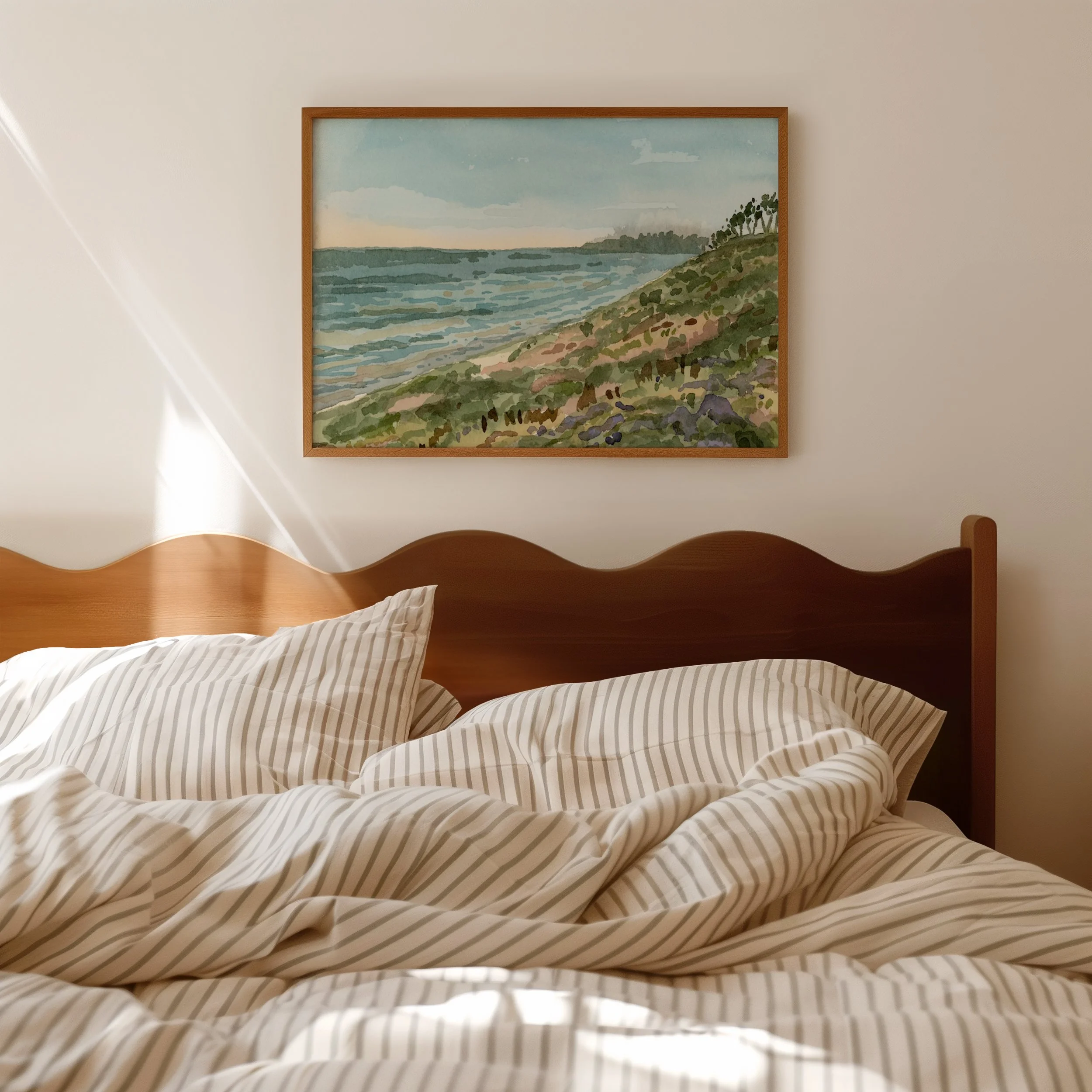 Tamarack Beach, Carlsbad coastal watercolor landscape wall art print inspired by Southern California's lush green coastline and vibrant blue Pacific Ocean hanging in a bedroom