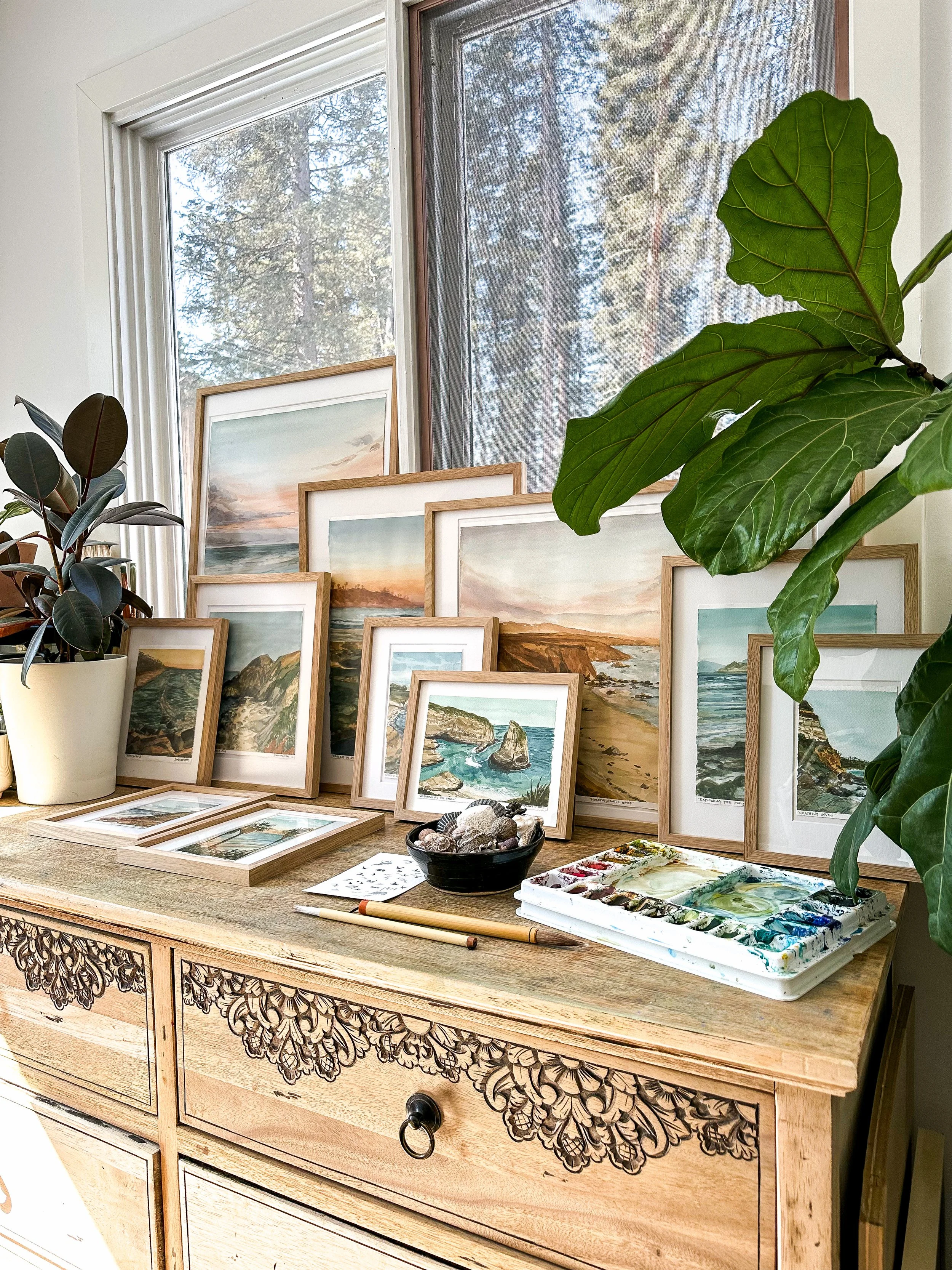 A Collection of coastal watercolour landscape paintings displayed in Rebecca Sobbi's art studio