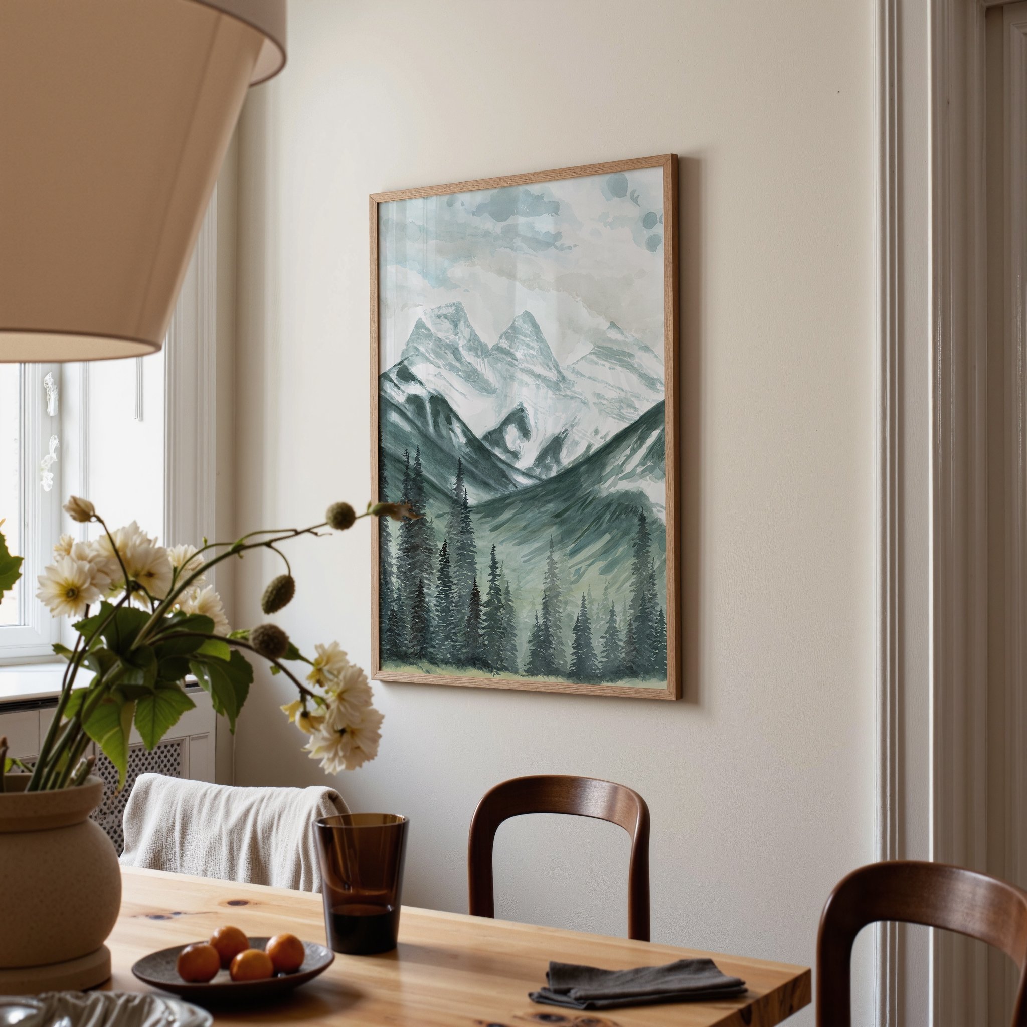 Three Sisters mountains, Canmore Alberta landscape watercolor wall art print inspired by snow capped mountains and towering evergreen trees in the Canadian Rockies hanging in a dining room