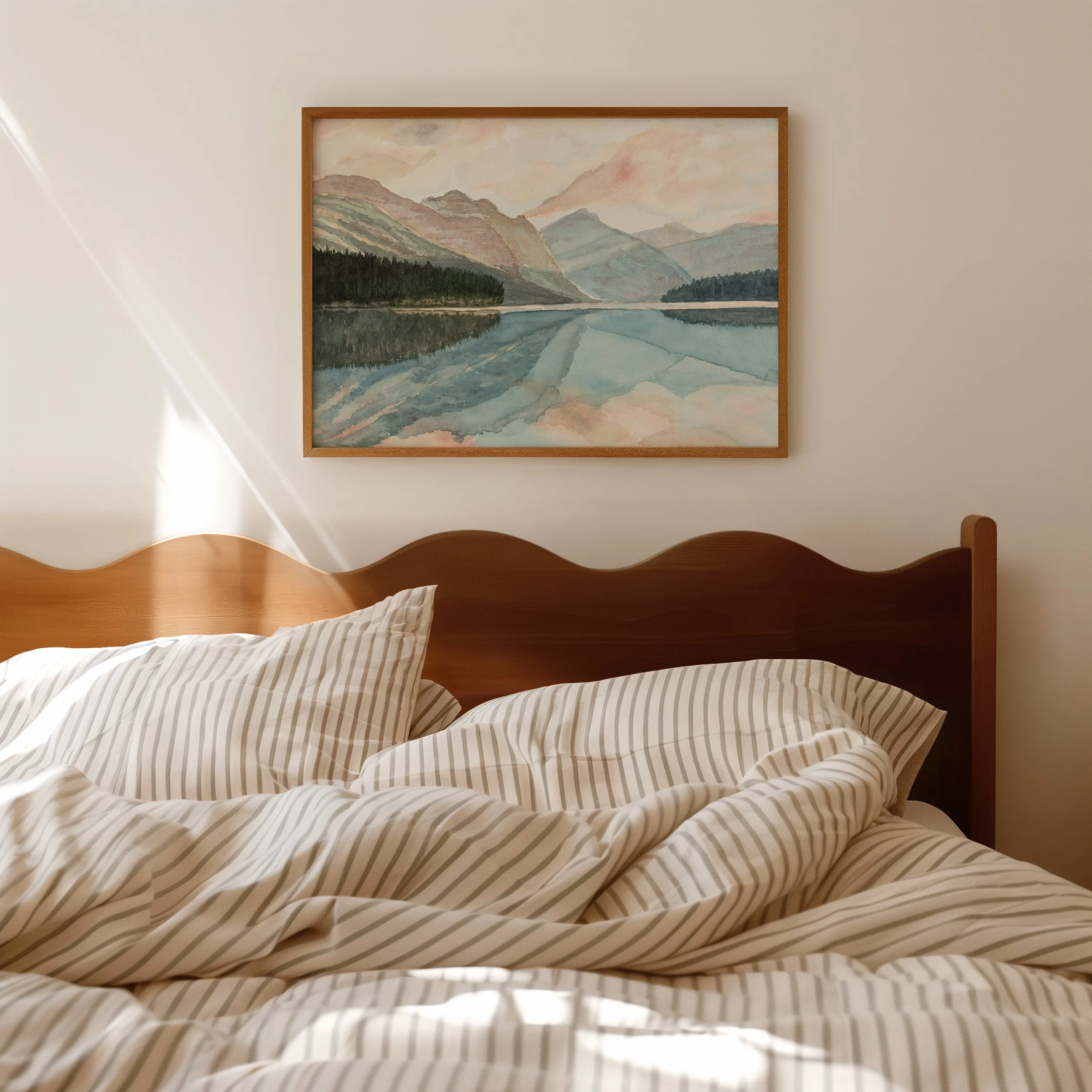 Framed Watercolour Art Print of Waterton Lakes National Park in Alberta hanging on a wall above a bed by Rebecca Sobbi