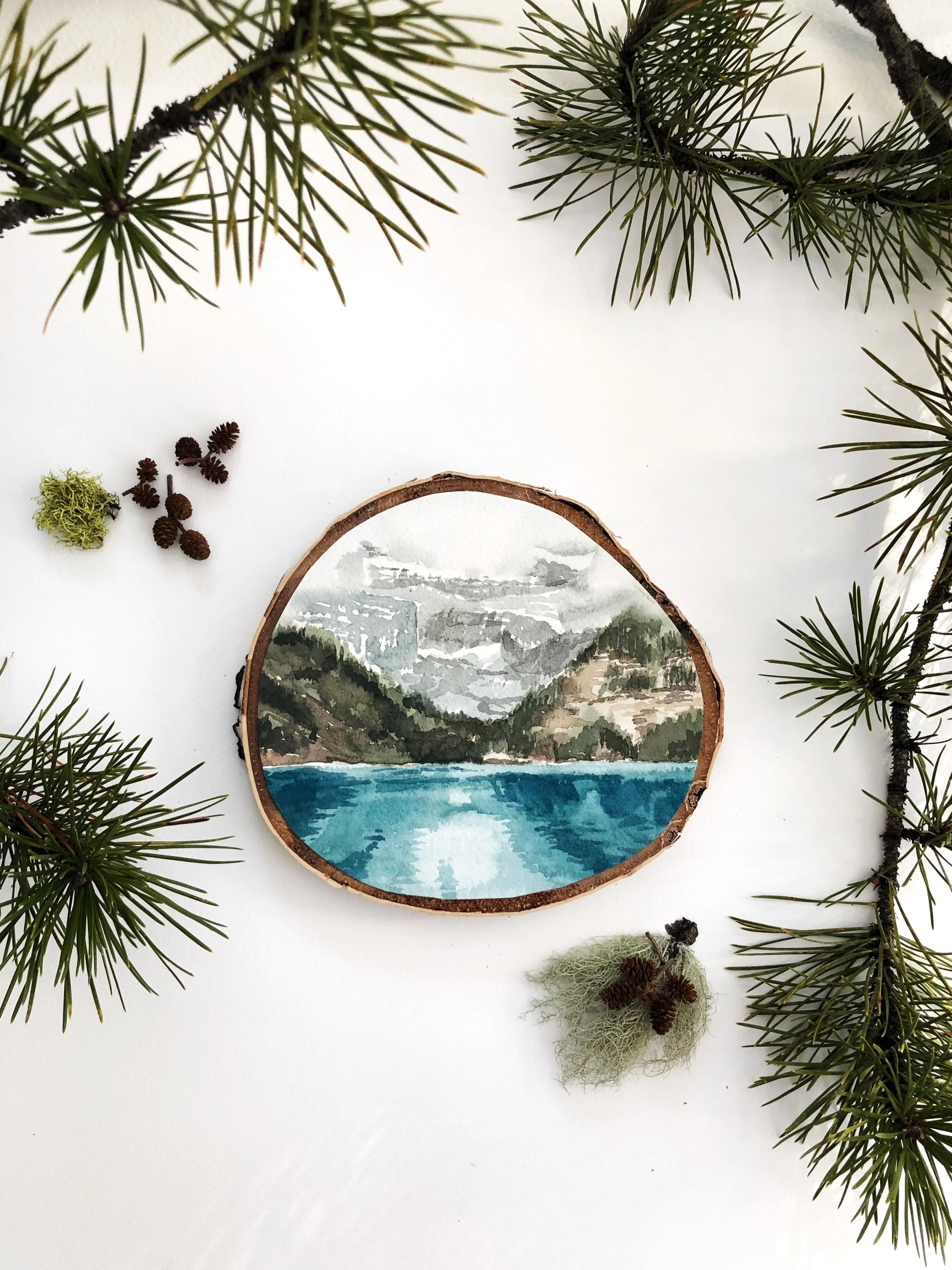 watercolor landscape painting of Lake Louise in Banff National park painted on a birch tree slab
