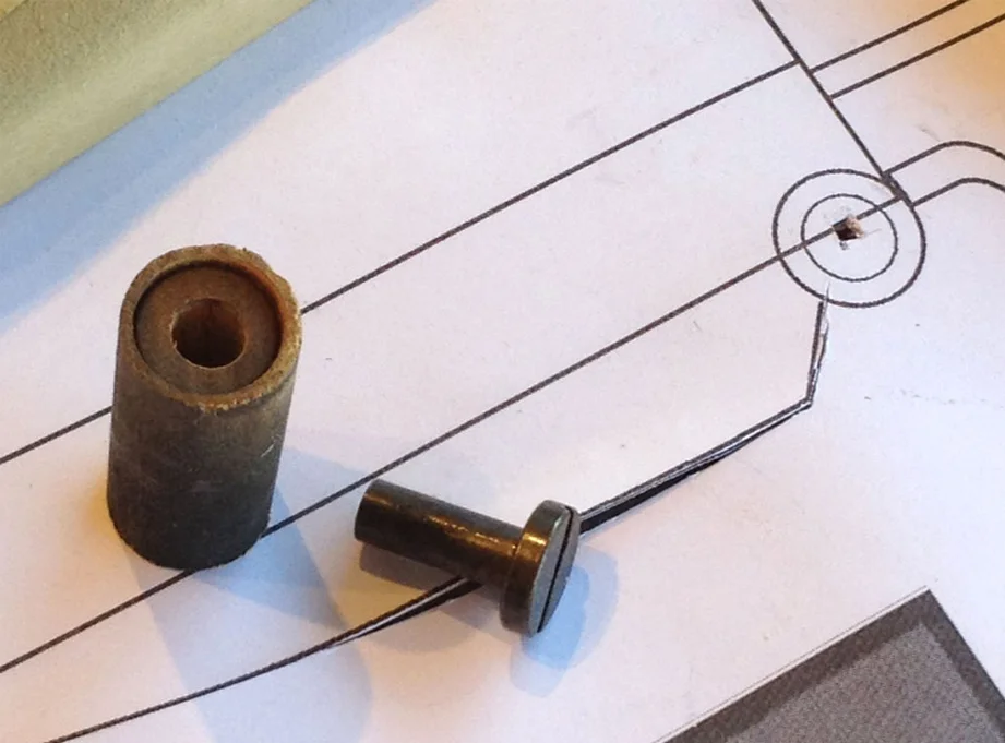 I drilled out the ends of the dowels and glued in the binding screws that the client sent.