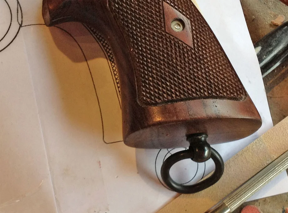 In prepping the grips for the prop, I had to carefully drill holes into the these expensive wood pieces. A hole was drilled under the grip for the lanyard ring.