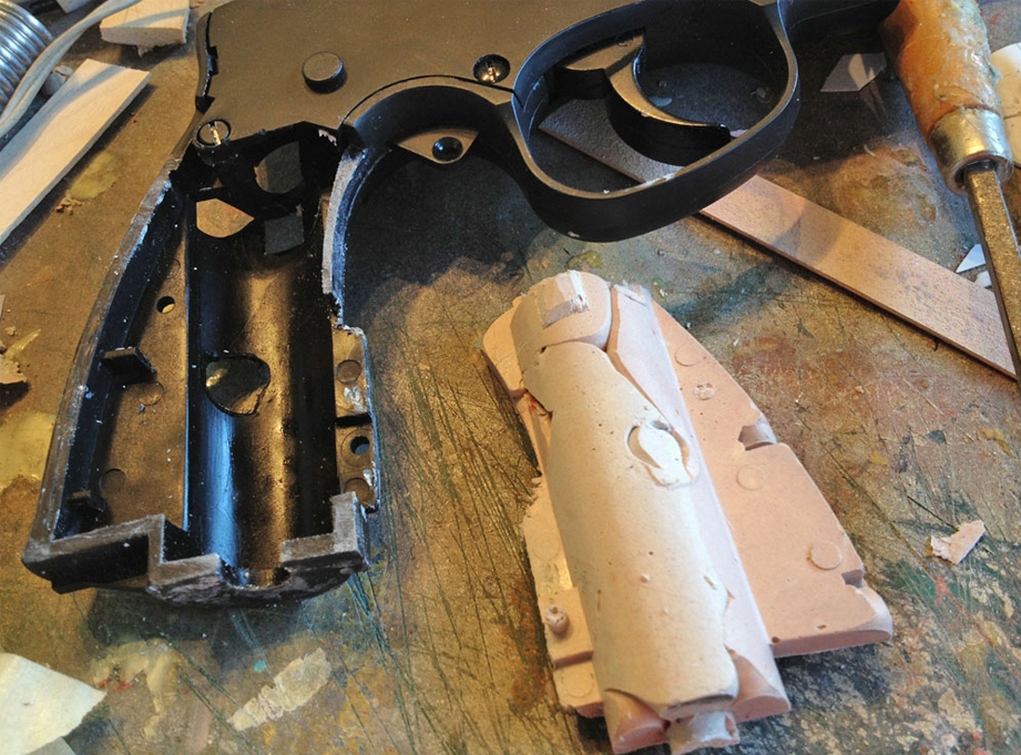  For the kit, I needed to make an insert to strengthen the frame of the airsoft gun. I sprayed the frame with mold release and then glopped a ton of Bondo into the space. Once it cured, I was able to pop out a perfect insert. 