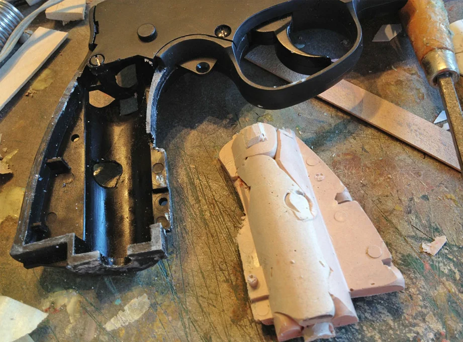 For the kit, I needed to make an insert to strengthen the frame of the airsoft gun. I sprayed the frame with mold release and then glopped a ton of Bondo into the space. Once it cured, I was able to pop out a perfect insert.