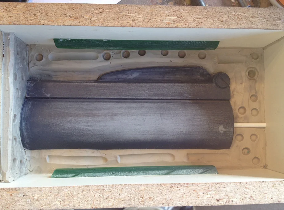 To make a mold of this piece, I had two choices. One involved cutting the piece down the middle for two 2-part molds or keeping the master in one piece and making a 3-part mold (two sides and an end plug for the barrel). I wanted to keep the rifling whole so I chose to do the 3-part mold. I sealed off the end and poured each side.