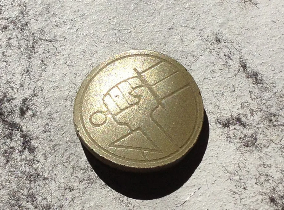 I mixed brass powder into my resin to cold cast the B.P.R.D. seals for the grip. They were shined up by buffing with 000 steel wool.
