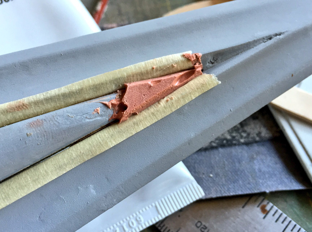  I masked off the edge of the blade and used Bondo to complete the tip of the shaft. 