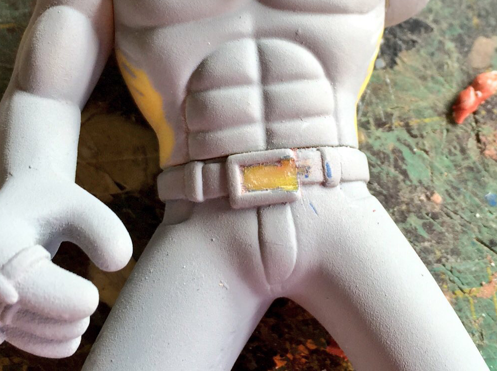 Next I needed to change the belt buckle to match the drawings from the show. I cut away the extra plastic and later added a small piece of styrene to make the tongue.