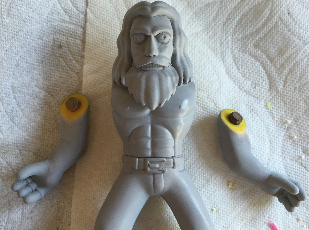 I had originally intended to mold the figure as one piece, but I changed my mind. I cut of the arms and used bits of steel bar to make pegs.