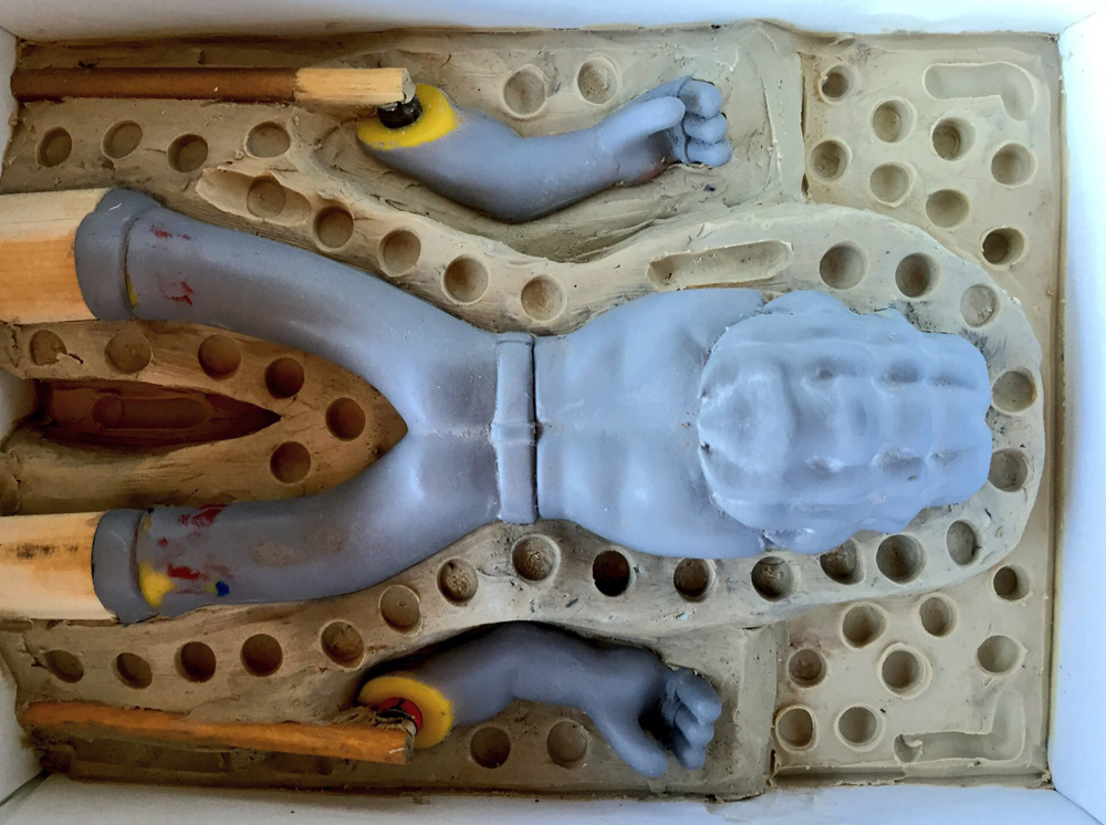 I made a clay bed to mold the figure. Bits of wood make pour spouts. 