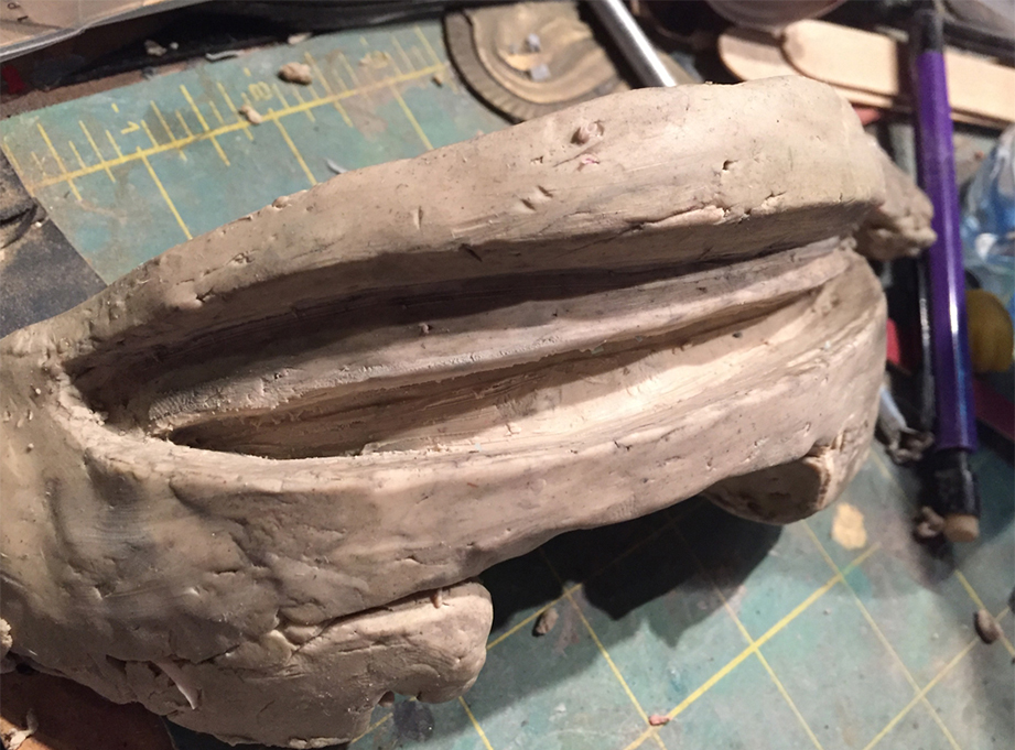  I smashed some clay inside the head and sculpted a new mouth and teeth. 