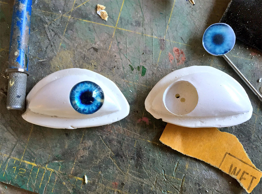  I used a forstner bit to drill a hole in each eyeball. The new pupil just slides in. 