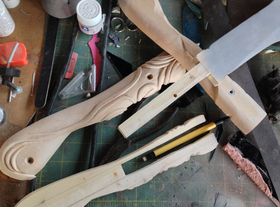  Carving the hilt while the blade was attached was cumbersome so I cut out a tang for the blade from the middle slice. 