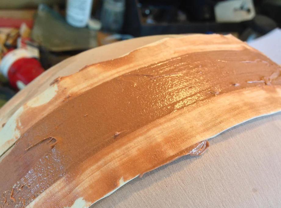 Bondo was squeegeed between the tape barriers using a flexible piece of plastic.