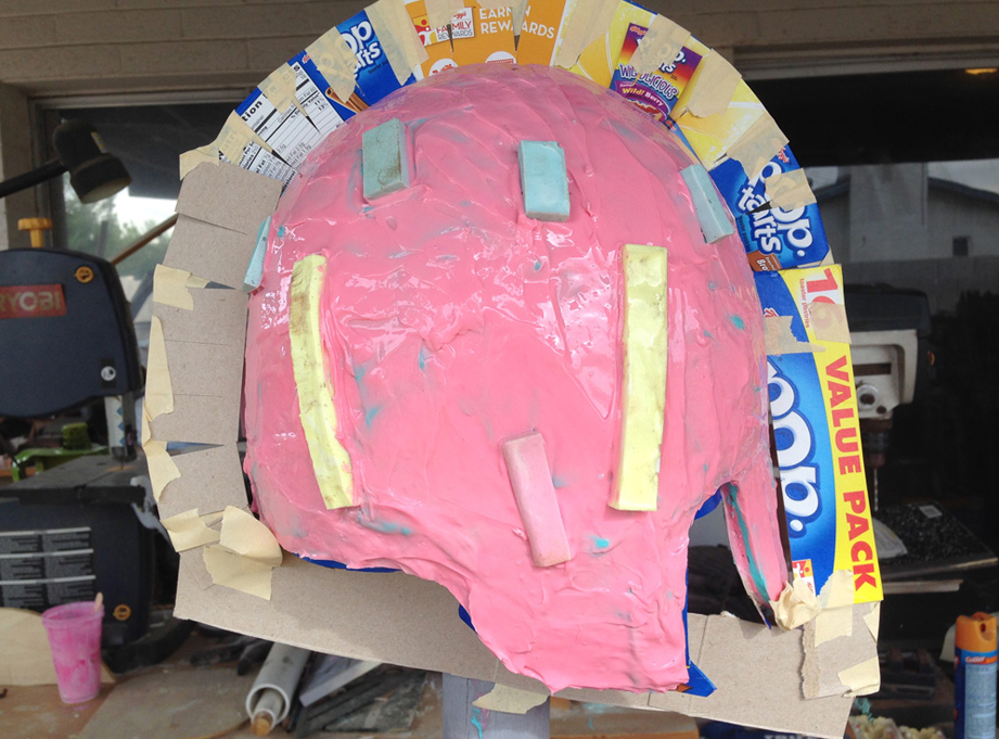  Several coats of Stroke later and keys applied to the final coat. I taped more cardboard to “trace” the profile of the helmet. 