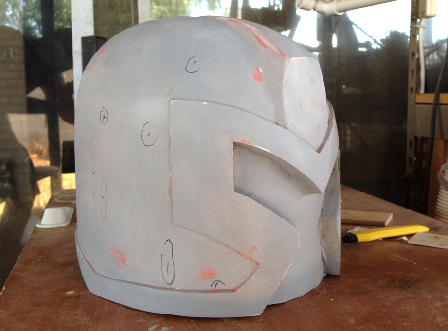  Holding the helmet in strong light, I could see all the imperfections. I marked the low areas with a "-" and the high areas with a "+" 