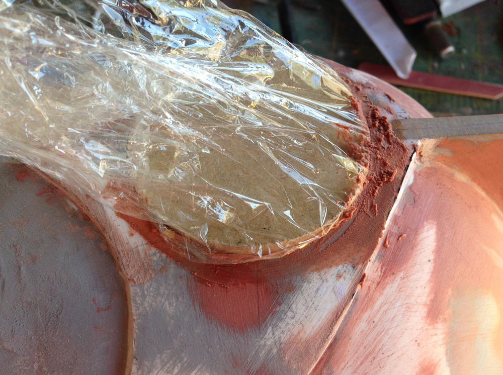  I cut a puck from 1/4” MDF for the emblem master. I wrapped it in plastic wrap to clean up the hole around the emblem. 