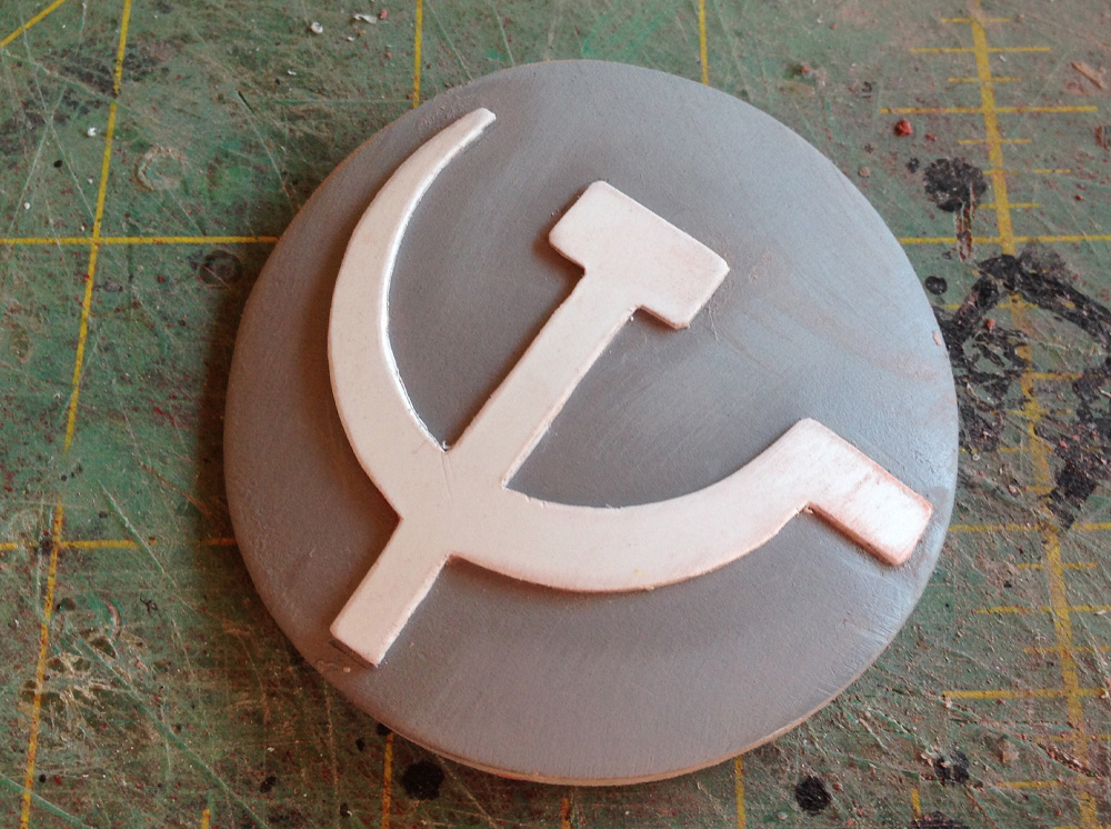 I drew and cut out a styrene plastic hammer and sickle and glued it to the emblem (reversed in the comic book universe.)