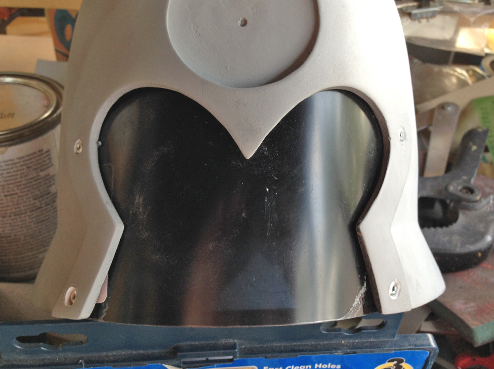 The visor was secured with pop rivets. The holes were filled with Bondo and sanded smooth.