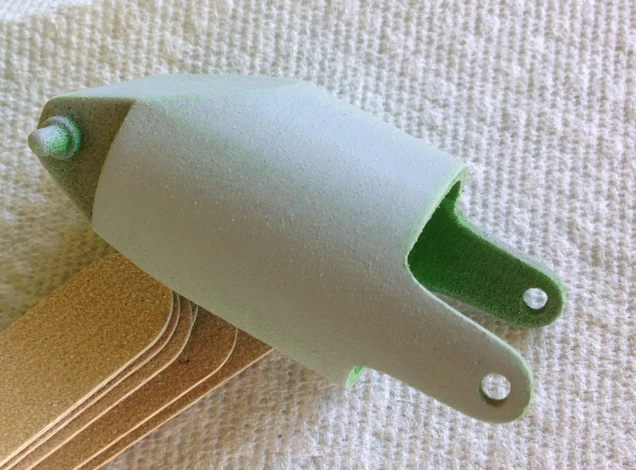 A coat of filler primer removes most of the print marks. The green plastic make it easier to paint as I don't have to worry about getting color in the recesses.