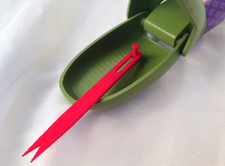 The tongue is secured to the lower jaw with a pin. The slot allow the tongue to dart in and out of the mouth as well as moving side to side.