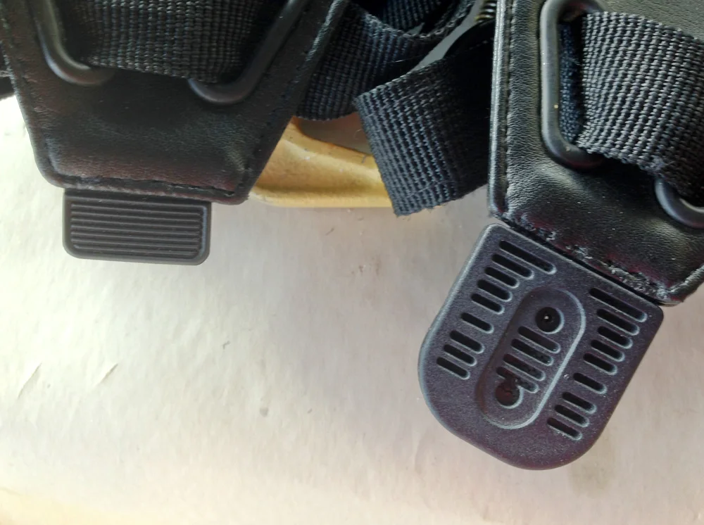 The stock vests come with a plastic tab at the base of the shoulder armor that needed to be replaced by an accurate luggage handle (right).