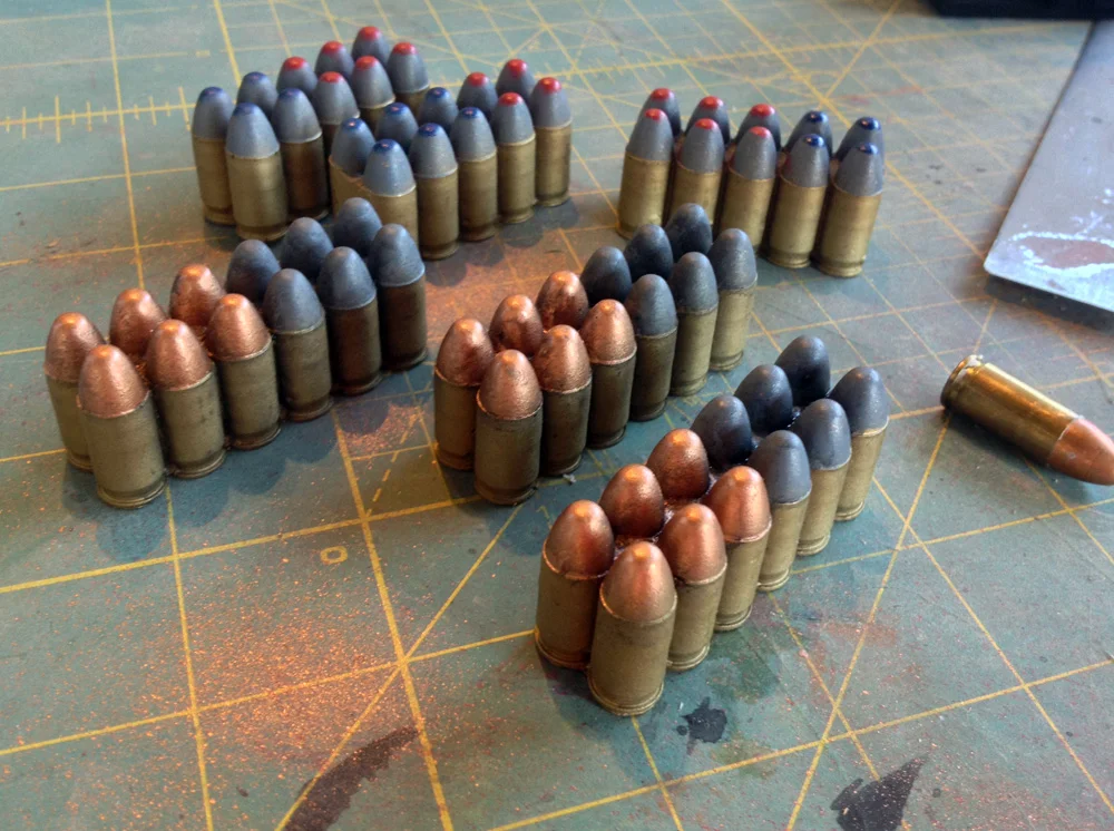 Since the shells are visible in the front magazine, they needed to be painted. The film version looked silver but I opted for a more real world color scheme of brass for the shells and color-coded tips for each type of round.