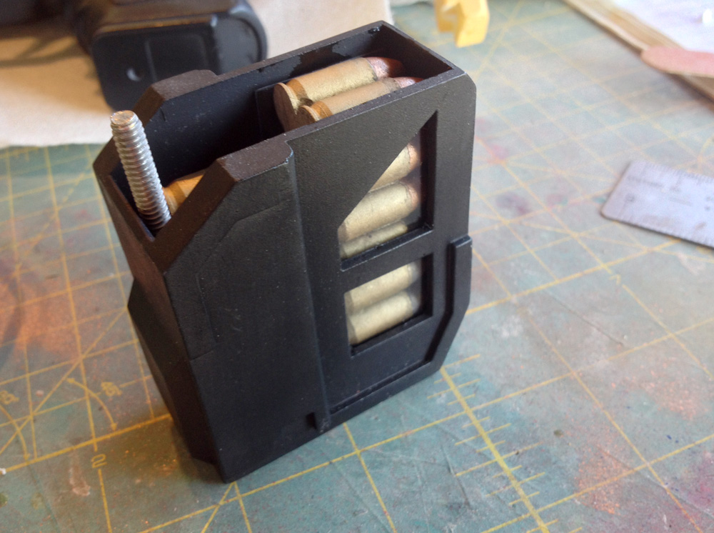  The front magazine loaded with the mounting bolt sitting behind the rounds. 