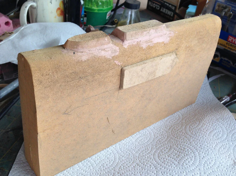 To make the holster, I bought some .09″ Kydex plastic on eBay. This plastic is widely used for heat formed holsters for real guns and is what they used in the movie as well. I measured the Lawgiver and used MDF to make a master to form around.