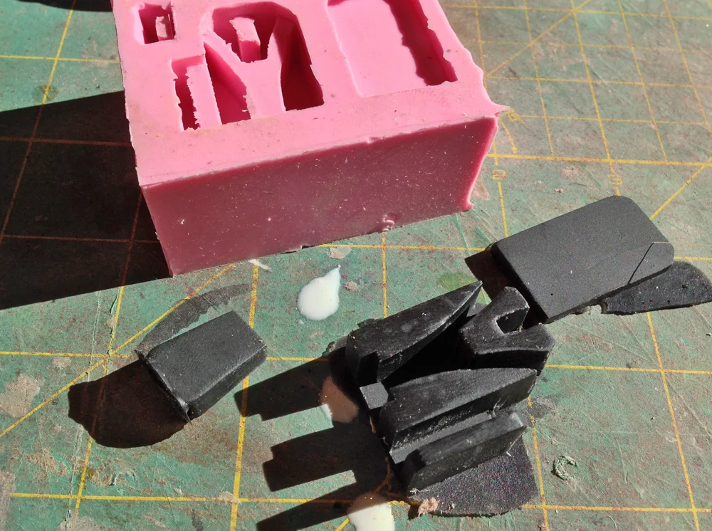 By looking at photos of screen used props and other people’s cuff builds, I built the parts for the zip cuffs and made a mold of them. The cuff mechanism consists of an end cap, the cuff lock box and a cover plate. Here is an Onyx cast resin copy.