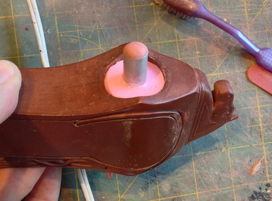 I inserted an aluminum rod and poured silicone into the handle hole. The rod will help with registration of the mold parts and make it easier to remove the plug from castings.