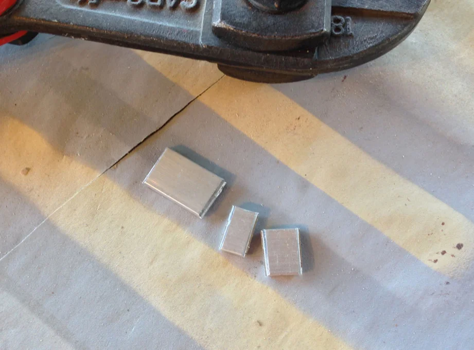 One little detail I needed to add was the metal wedge that’s embedded into the end of the handle that keep the axe head from flying off. I cut scrap aluminum pieces.