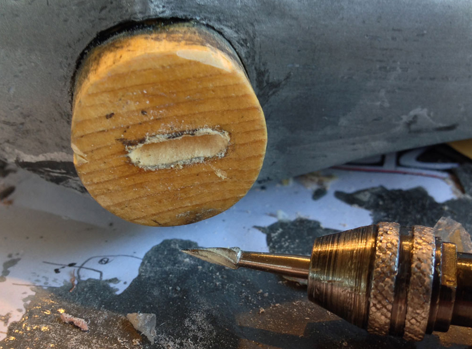  I didn’t want to stress the plastic of the head by hammering in the wedge, so I cut a shallow hole in the top of the handle with a rarely-used Dremel cutter. 