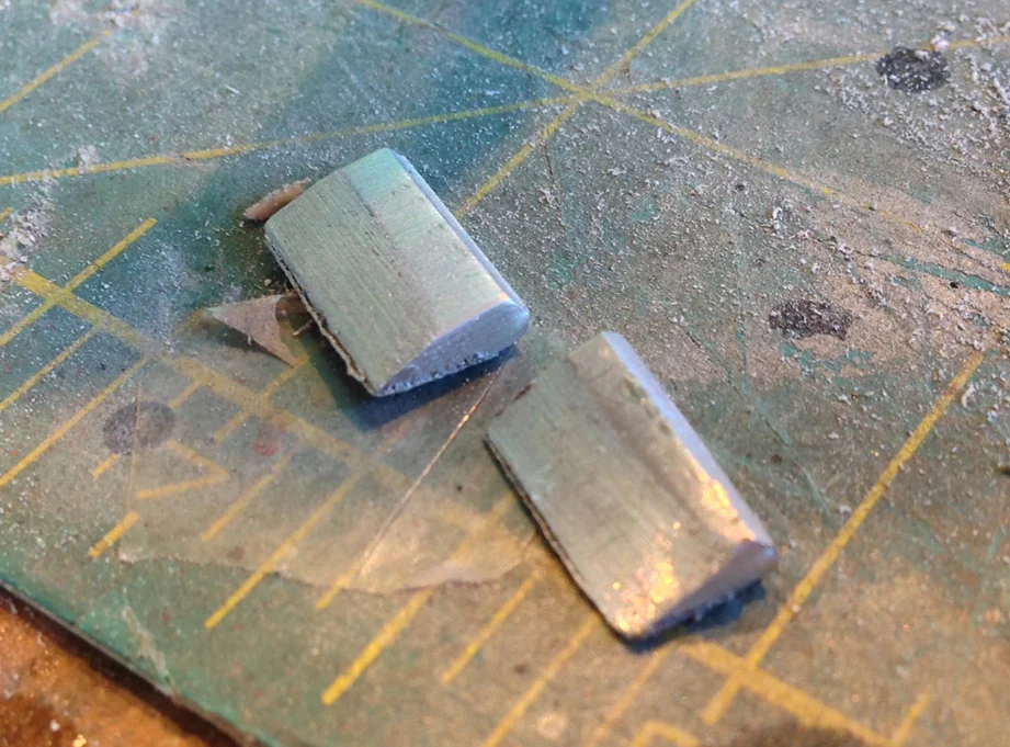 A quick trip to the belt sander turned them into rough wedges. Since they’re only cosmetic, they didn’t need to be very deep.