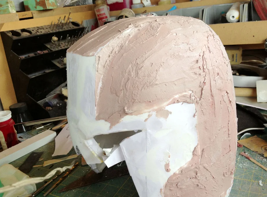 After sanding off the folds of the paper, I added Bondo to smooth out the contours. Because of my lousy paper model build, I had to do a lot of corrections to the geometry of the helmet.