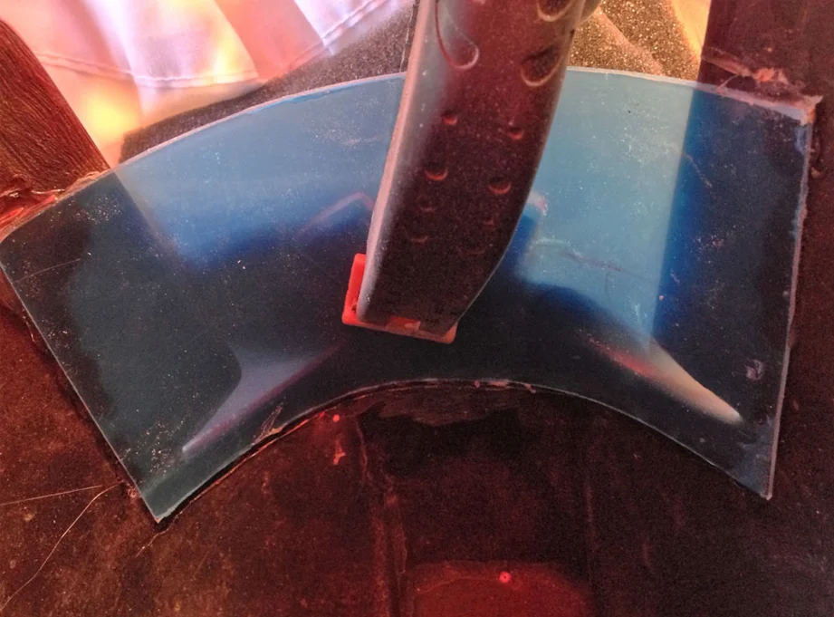 The visor was positioned and then held in place with a clamp. I then ran a bead of hot glue along the inside of the visor.