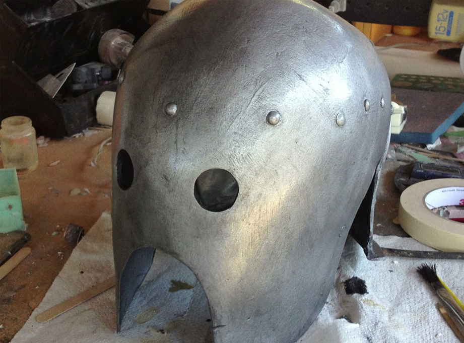 A wash of black acrylic paint knocks back the shine, brings out detail and makes it much more realistic looking.
