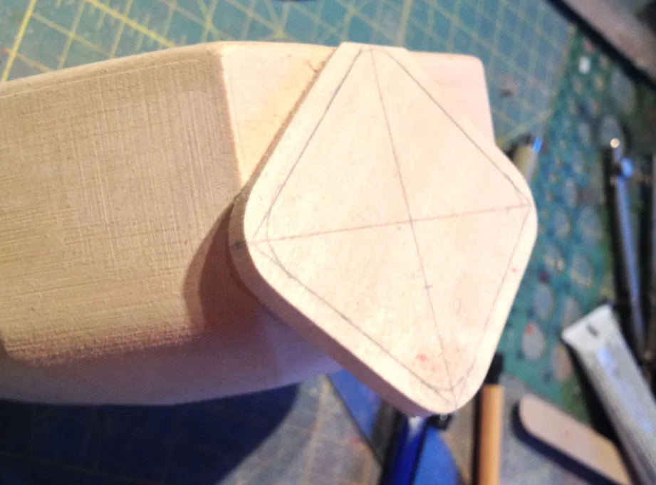 I cut a piece of basswood to make the chest shield and sand an angle to the back so it sits properly.