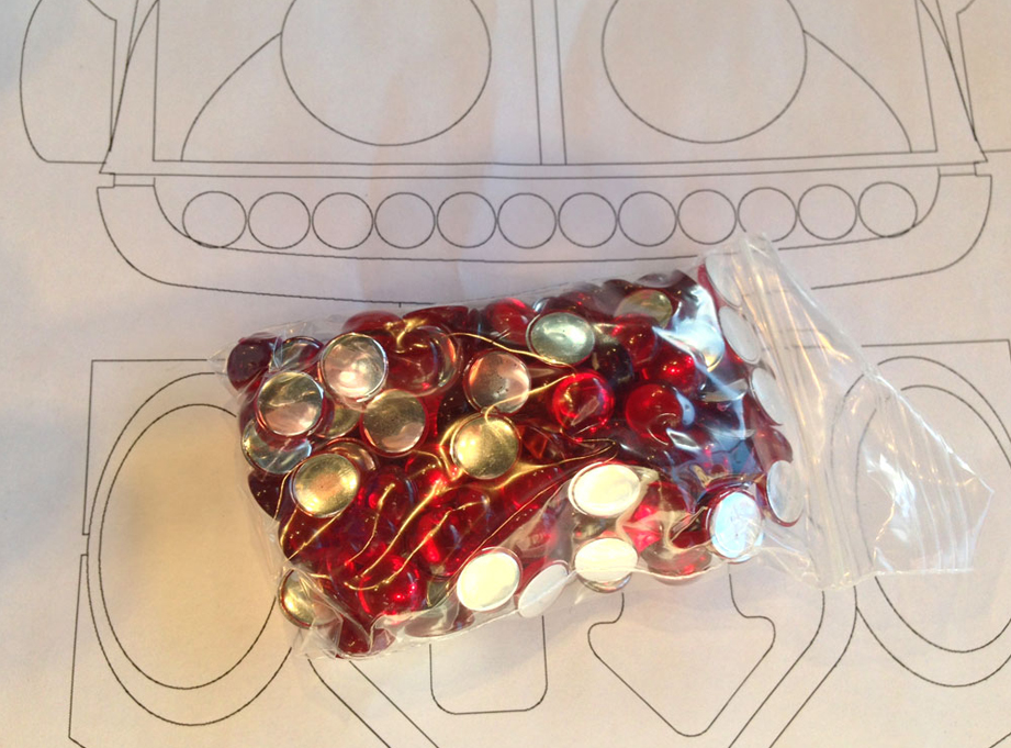  I purchased red acrylic cabochons for the teeth. They have a silver backing that really reflects the light. 